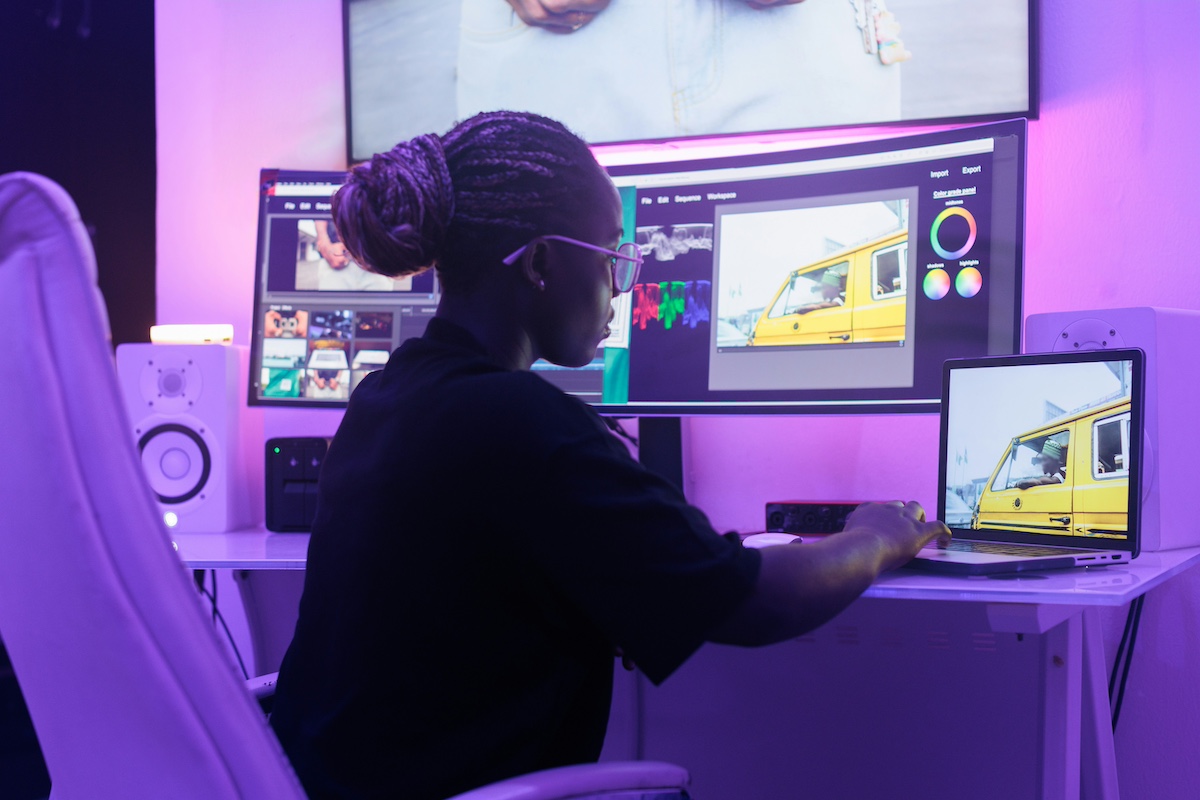 A lady editing a film in an editing suite.