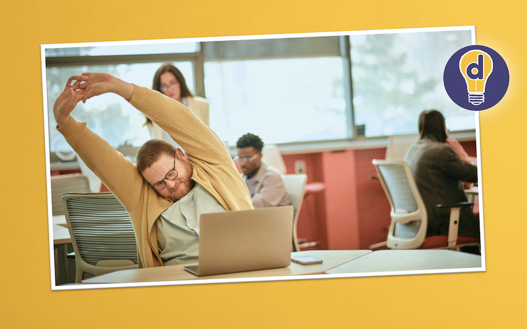 A man doing some boring corporate training and having a stretch.